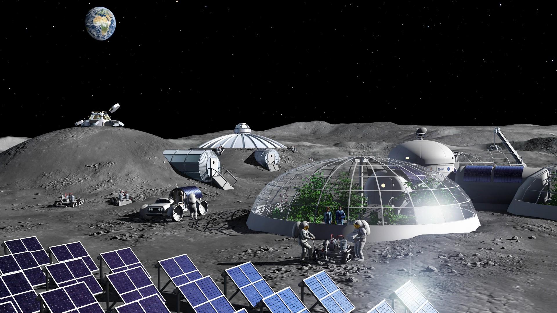 astronauts in bulky space suits walk on a dusty grey surface among glass-domed habitats under a black starless sky