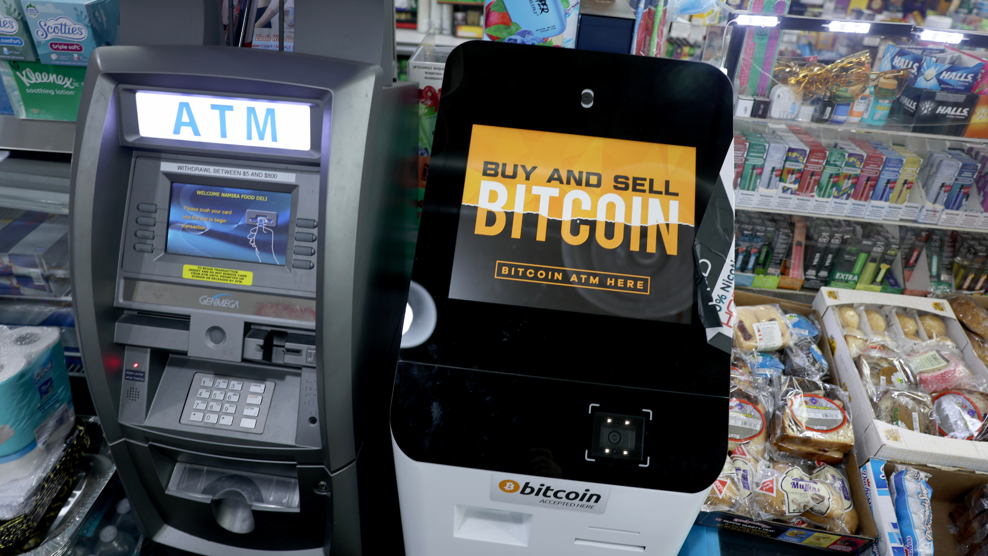 a Bitcoin ATM in a convenience store beside a traditional ATM